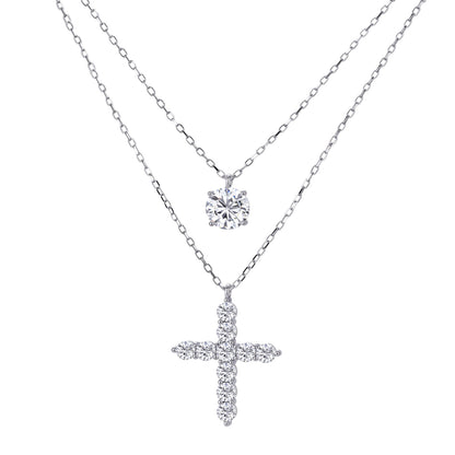 Two delicate sterling silver necklaces with moissanite stones - one solitaire pendant and one cross pendant on white background.