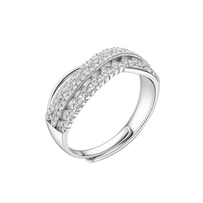 Sterling silver crossover ring with pavé-set moissanite stones creating an elegant infinity design on neutral background