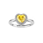 Heart-shaped yellow moissanite ring with diamond halo in sterling silver setting on neutral background