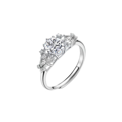 Sterling silver ring with oval moissanite center stone surrounded by smaller accent stones in ornate setting