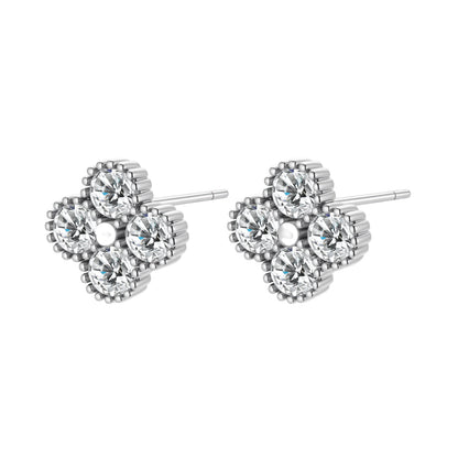 Dainty sterling silver quatrefoil stud earrings with four brilliant moissanite stones and center accent on white background.