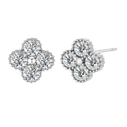 Dainty sterling silver quatrefoil stud earrings with four brilliant moissanite stones and center accent on white background.