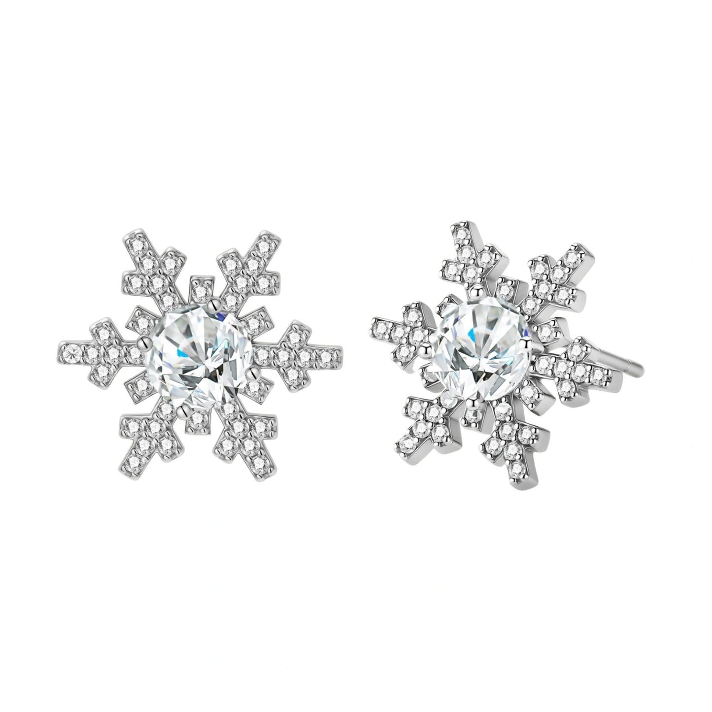 Sterling silver snowflake stud earrings with brilliant moissanite centers and intricate geometric patterns on cream background
