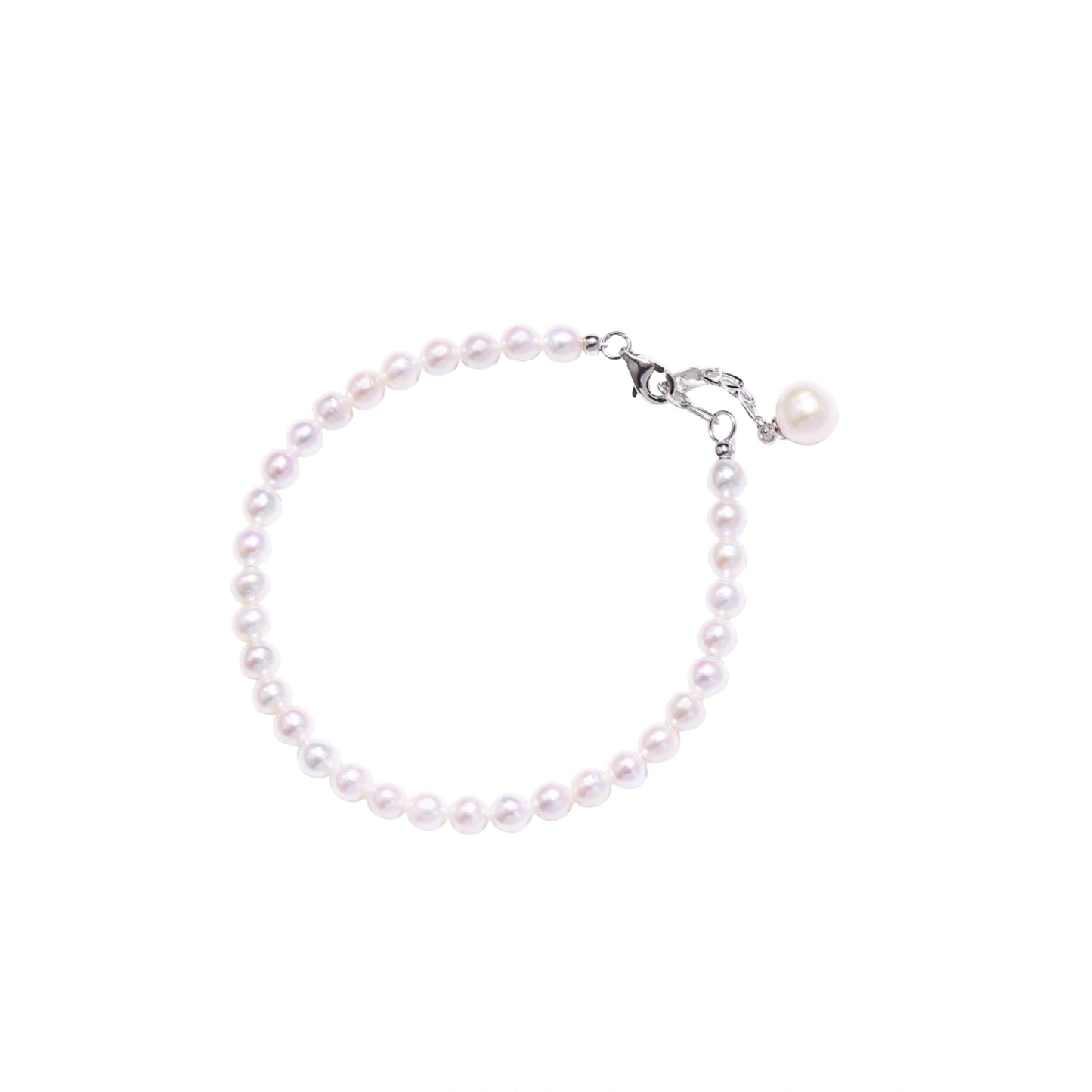 Adjustable bracelet featuring lustrous freshwater pearls with rhodium-plated sterling silver clasp on cream background.