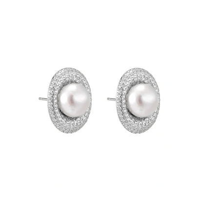 Elegant stud earrings with cream freshwater pearls surrounded by sparkly pavé crystals on rhodium-plated silver setting