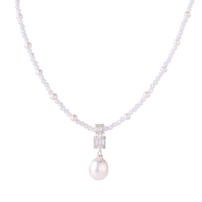 Dainty necklace with lavender crystal beads, freshwater pearls, geometric pendant, and large pearl drop on white background.