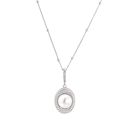 Oval sterling silver pendant with crystal halo surrounding a white freshwater pearl on delicate chain