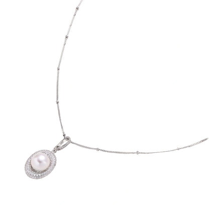 Oval sterling silver pendant with crystal halo surrounding a white freshwater pearl on delicate chain
