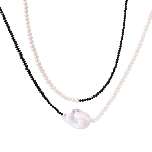 Double-strand necklace with black faceted quartz and white pearls featuring an oversized baroque pearl centerpiece