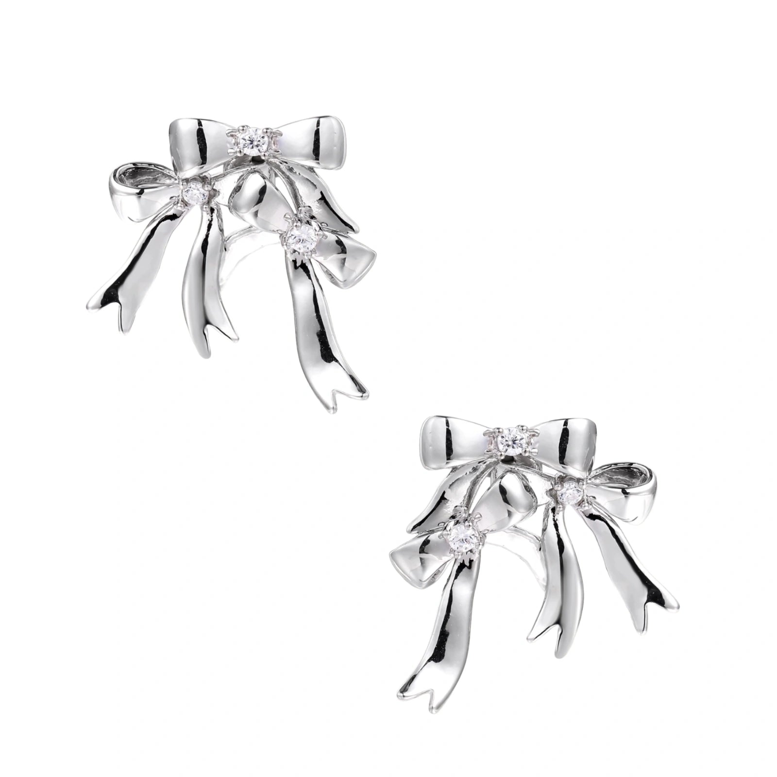 Sculptural bow earrings in polished white gold plate with sparkling zirconia stones and flowing ribbon details