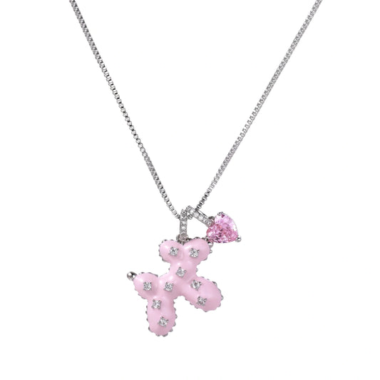 Pink enamel teddy bear pendant with crystal accents and heart charm on white gold chain