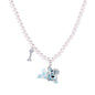 Pearl necklace with playful blue dog pendant accented with sparkly crystals on cream background.