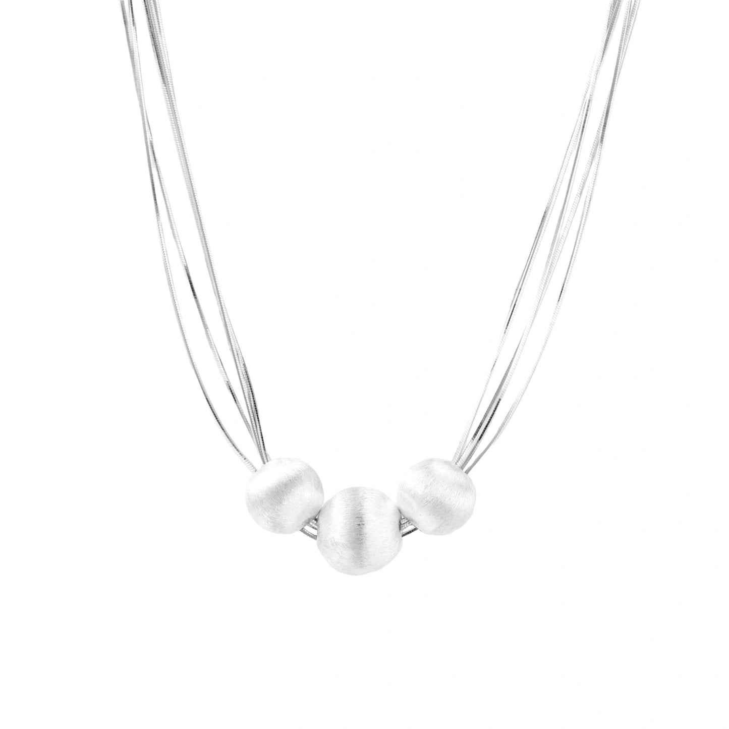 Sterling silver multi-strand necklace with three brushed round beads on cream background