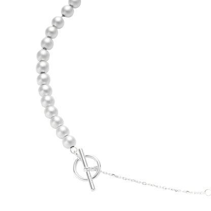 Long sterling silver beaded necklace with graduated sphere design, toggle clasp, and delicate chain extension on white background