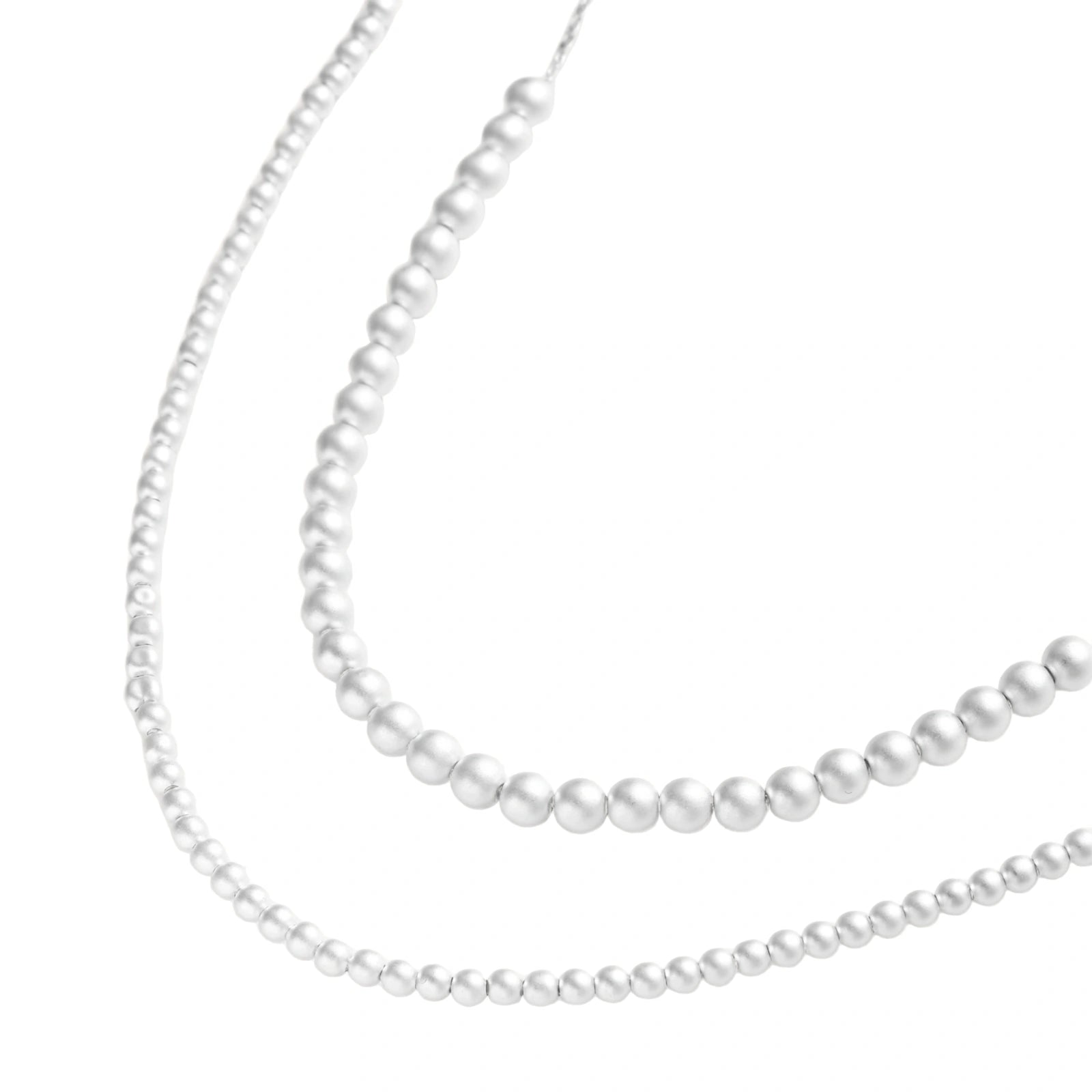 Long sterling silver beaded necklace with graduated sphere design, toggle clasp, and delicate chain extension on white background