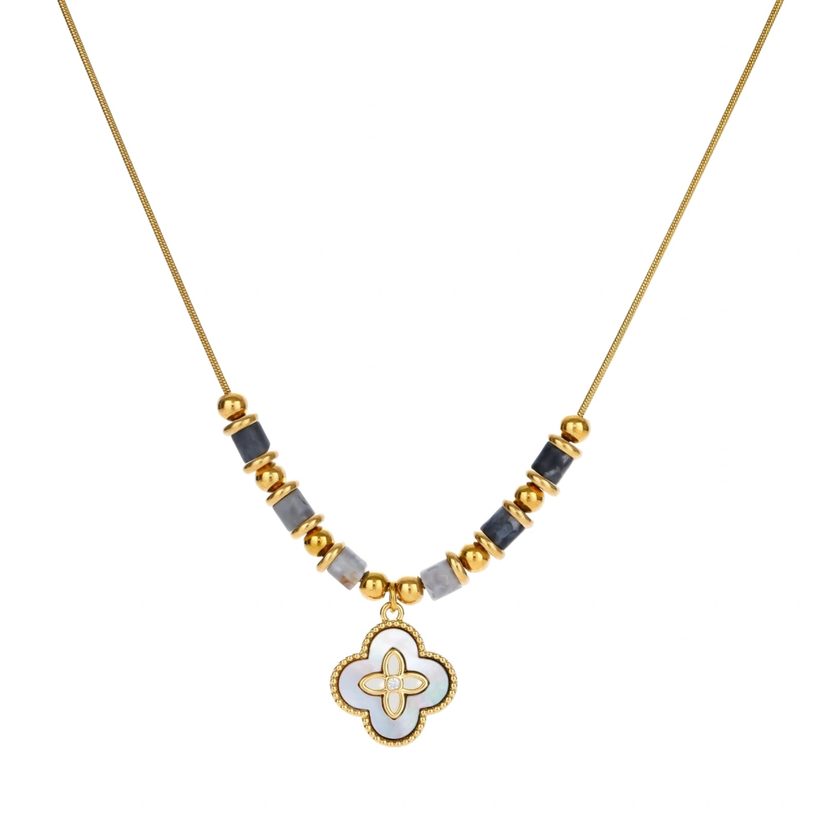 Gold-toned beaded necklace with grey stones and quatrefoil abalone shell pendant on cream background.